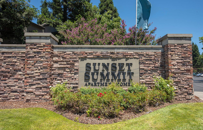 A stone wall with a Sunset Summit Apartments sign on it at Sunset Summit, Rocklin, CA, 95765
