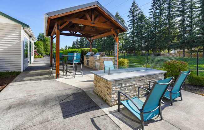 Outdoor Fire Pit & BBQ Area at Landings at Morrison Apartments located in Gresham, OR.