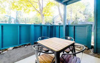 a patio with a table and chairs on a porch