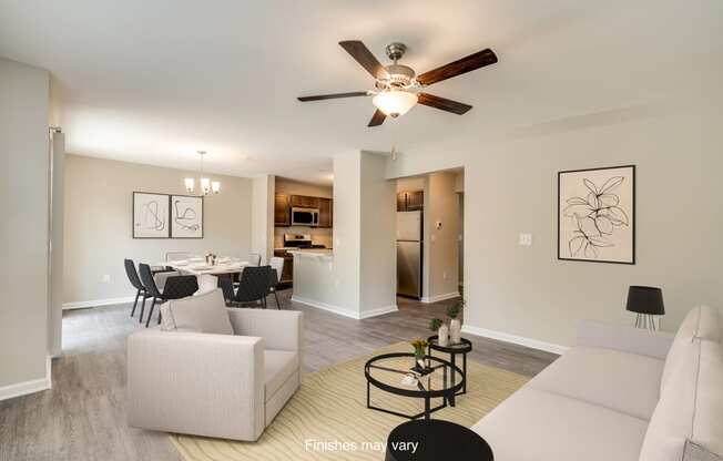 a living room and dining room with a ceiling fan