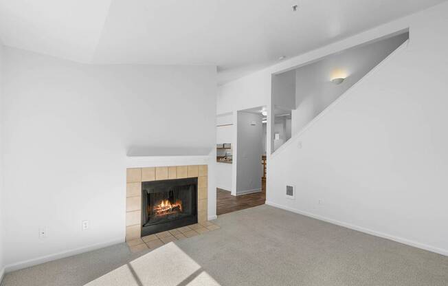 a living room with a fireplace and white walls