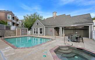 a pool and patio with a house in the background