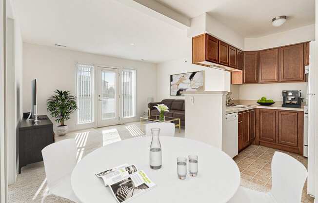 Buttercup Layout Model Dining Space with Kitchen View at The Harbours Apartments, Clinton Twp, MI 48038