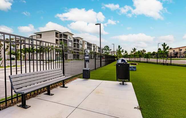dog park with green turf and a fence at Vantage Luxury Apartments in Cape Coral, FL