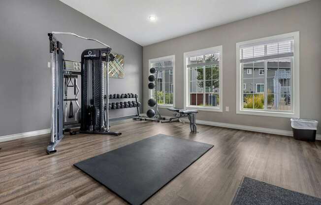 A spacious home gym with a variety of equipment.