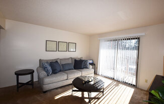 Living Room With Sliding Glass Door To Balcony at Granada Apartments, Jackson, Michigan