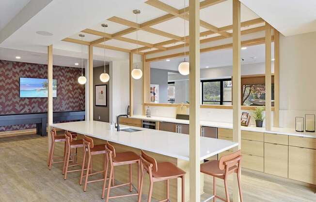A kitchen with a long white table and chairs.