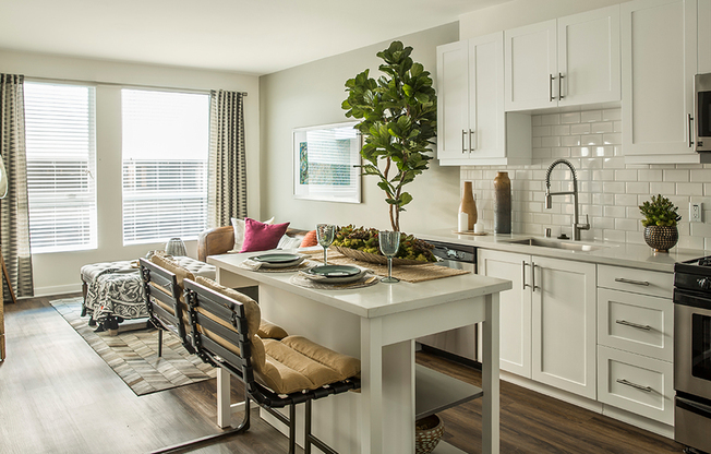 Modern kitchens outfitted with stainless steel appliances, quartz countertops and tile backsplashes