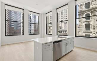 A kitchen with a large island and a dishwasher.