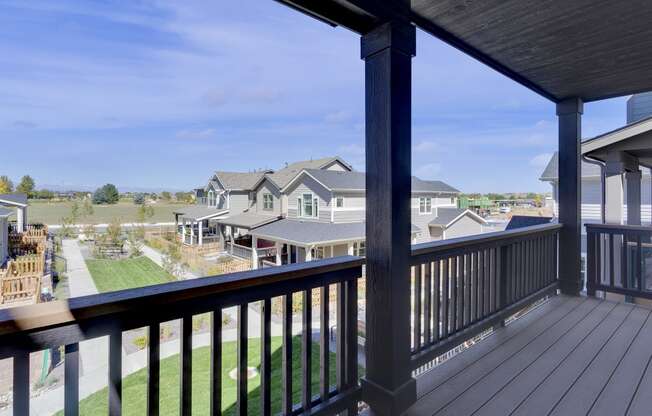 the view from the deck of a home with a yard and houses