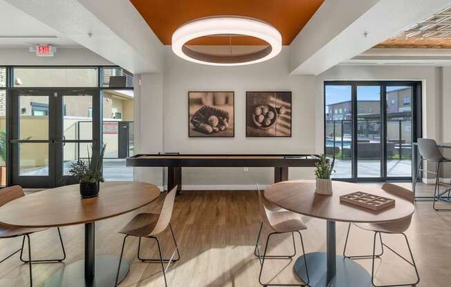 A modern dining area with a round table and chairs.