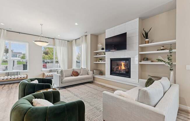 A living room with a fireplace and a television on the wall.