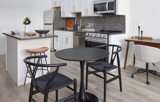 a kitchen and dining area with a table and chairs