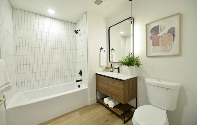 a bathroom with a toilet and a tub and a sink