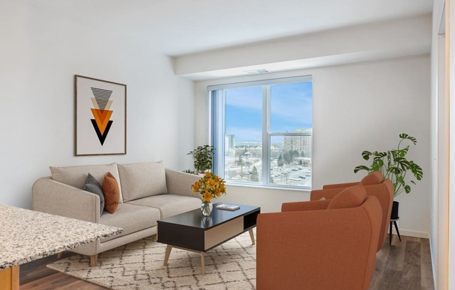 a living room with a couch and a table and a window