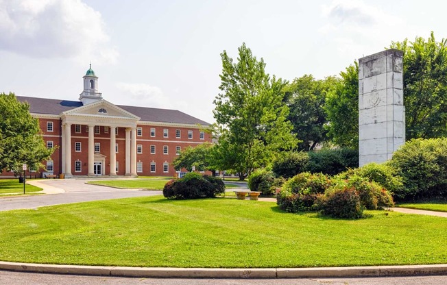 A large red brick building with a green dome on top.