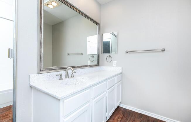 a room with a sink and a mirror