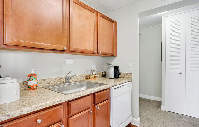 a kitchen with wooden cabinets and a sink