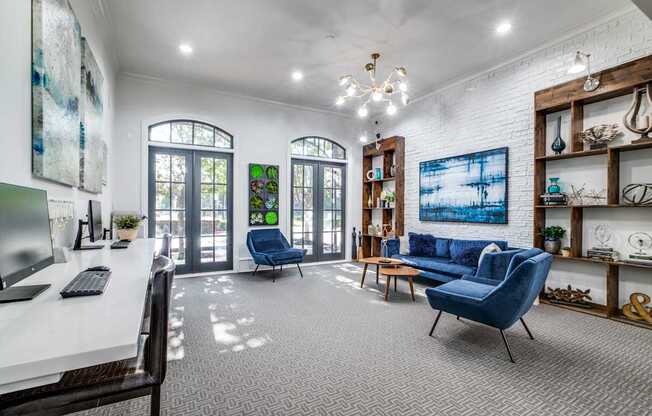 A room with a white desk and a blue chair.