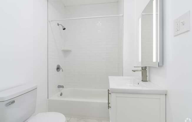 a white bathroom with a tub and a sink and a toilet at Clay & Tiffany, Portland, OR, 97201