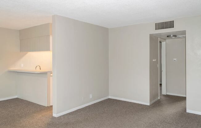 the livingroom leading to the kitchen and to the bedrooms in a park apartment home