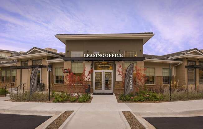 a building with the leasing office on the front of it