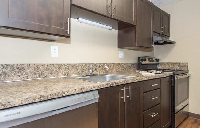 a kitchen with stainless steel appliances and granite counter tops