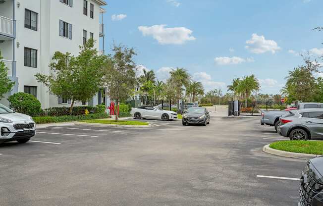 a parking lot with cars parked in front of a building