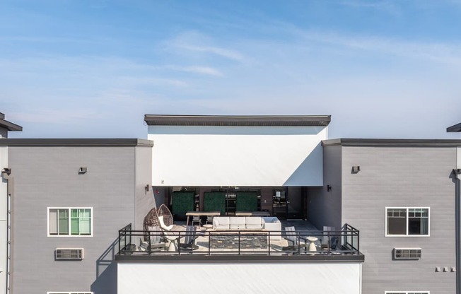 A modern house with a balcony and a white awning.