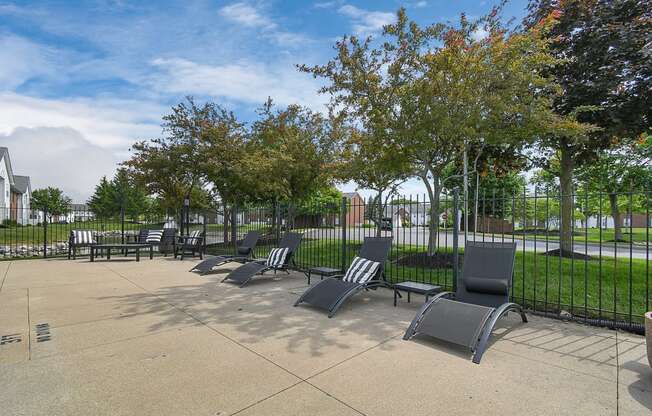 a row of park benches in front of a fence