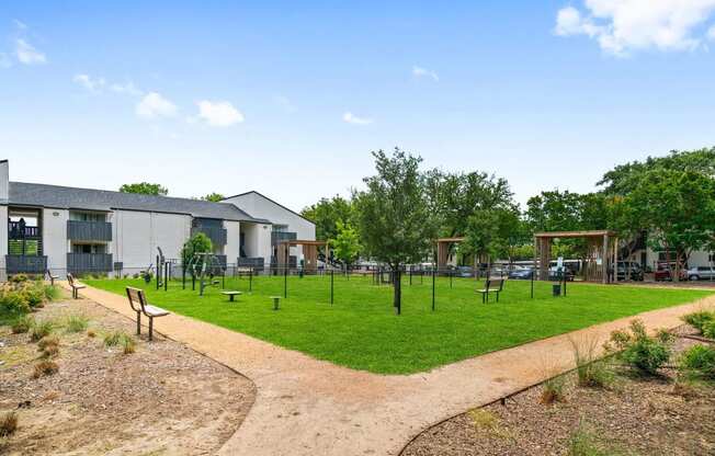 a park with a playground and a building in the background