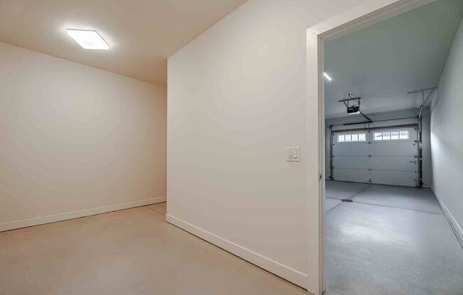 A white room with a doorway leading to another room.