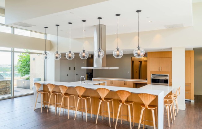 a large kitchen with an island and bar stools