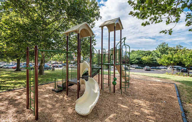 A playground with a slide and swings.