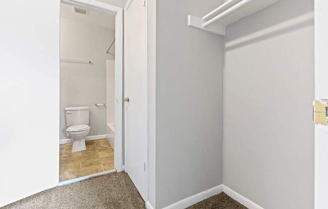 a bathroom with a toilet and a white door