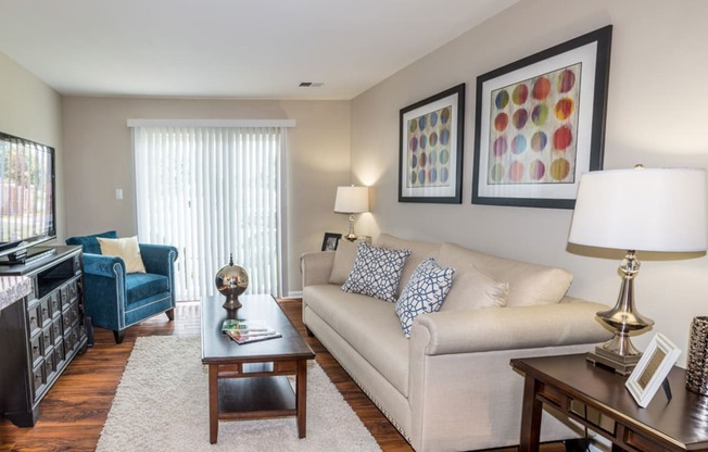 a living room filled with furniture and a large window at Misty Ridge Apartments, Woodbridge Virginia