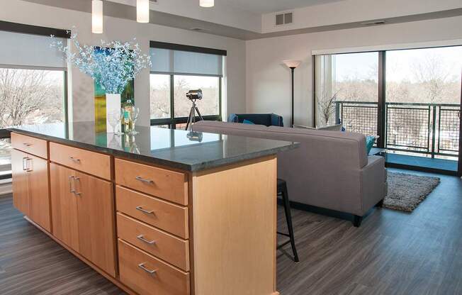 A kitchen with wooden cabinets and a black countertop.