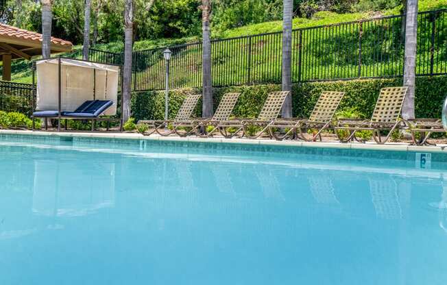 Pool and chaise lounges at 55+ FountainGlen Laguna Niguel