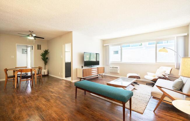 a living room filled with furniture and a large window