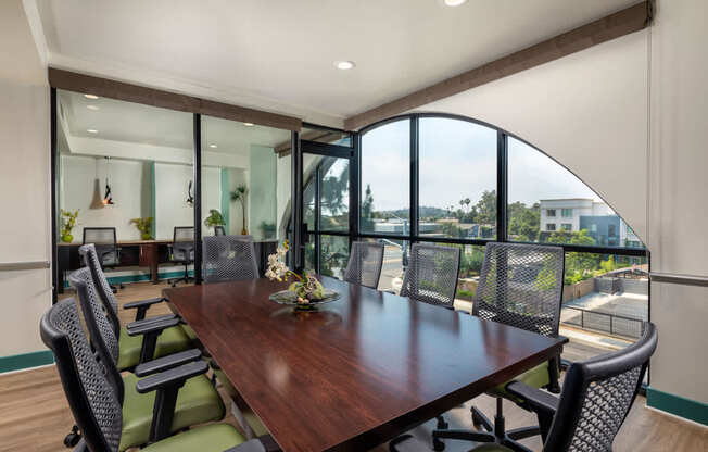 A conference room with a long table and chairs.