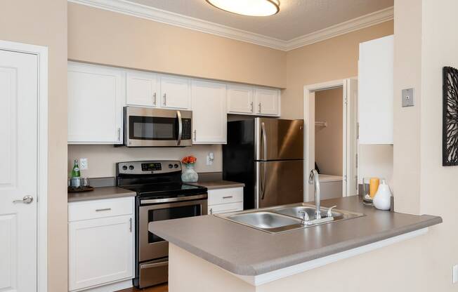 Weston Point Apartments - Fully-equipped kitchen with above range microwaves and refrigerators with icemakers