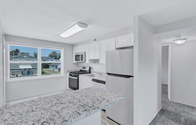 the preserve at ballantyne commons apartment kitchen with stainless steel appliances and granite counters