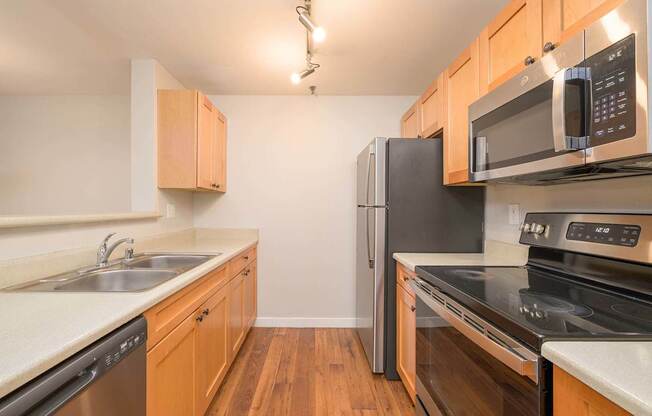 A kitchen with wooden cabinets and stainless steel appliances.