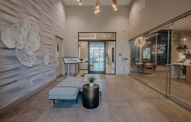 Level 25 at The Cruve's entry with decorative wall flowers, benches and kiosk stand.