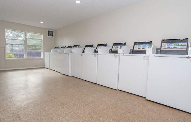 A row of washing machines inside an onsite laundry facility at The Creole Apartments in Shreveport, LA