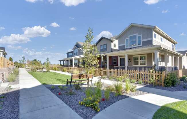 a house with a yard and a sidewalk in front of it