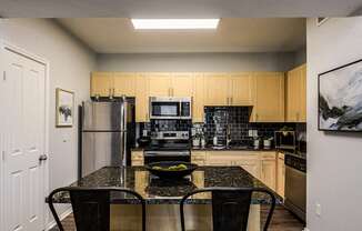 a kitchen with stainless steel appliances and a granite counter top