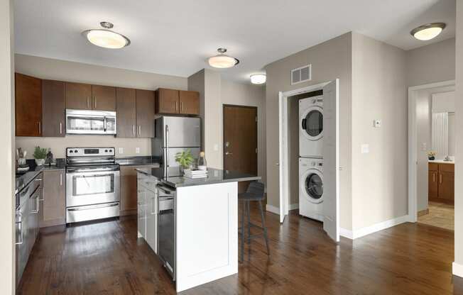 a kitchen with an island and a washer and dryer