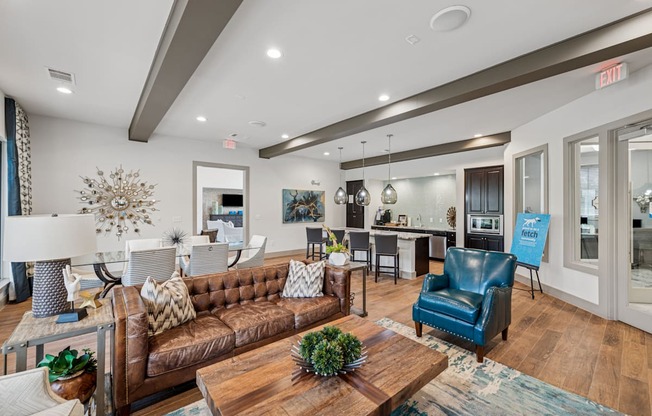A living room with a brown couch and a blue chair.