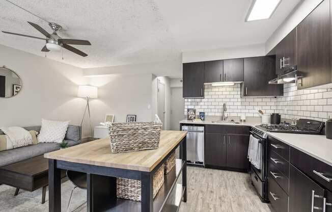 an open kitchen and living room with a dining room table